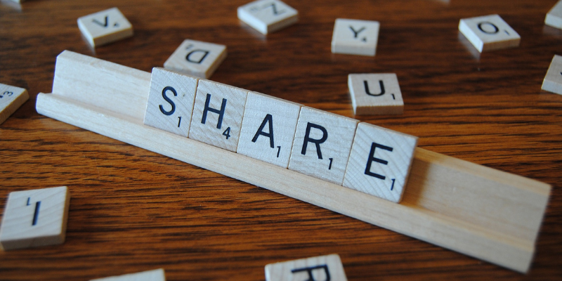 Picture of scrabble tiles spelling the word SHARE to represent the theme of sharing
