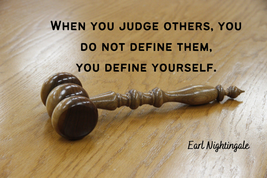 A picture of a gavel on a wooden desk with a quote about judgment - 