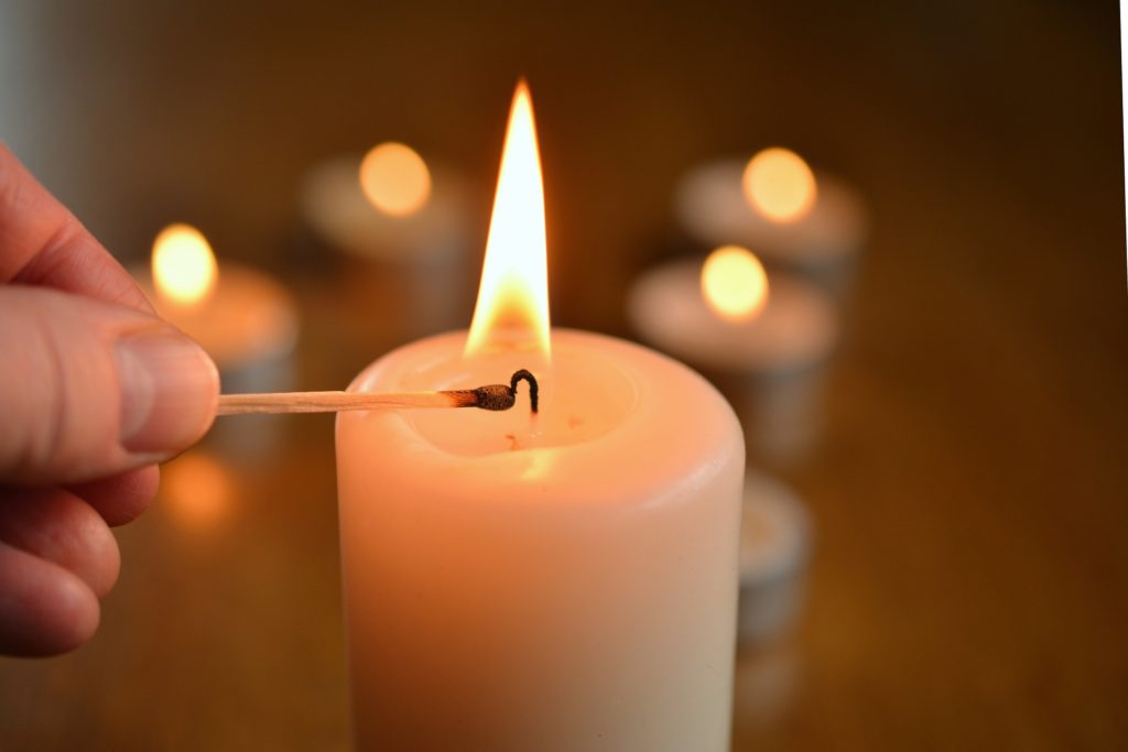 the journey of advent begins in stillness and quiet - picture shows lighting a single candle