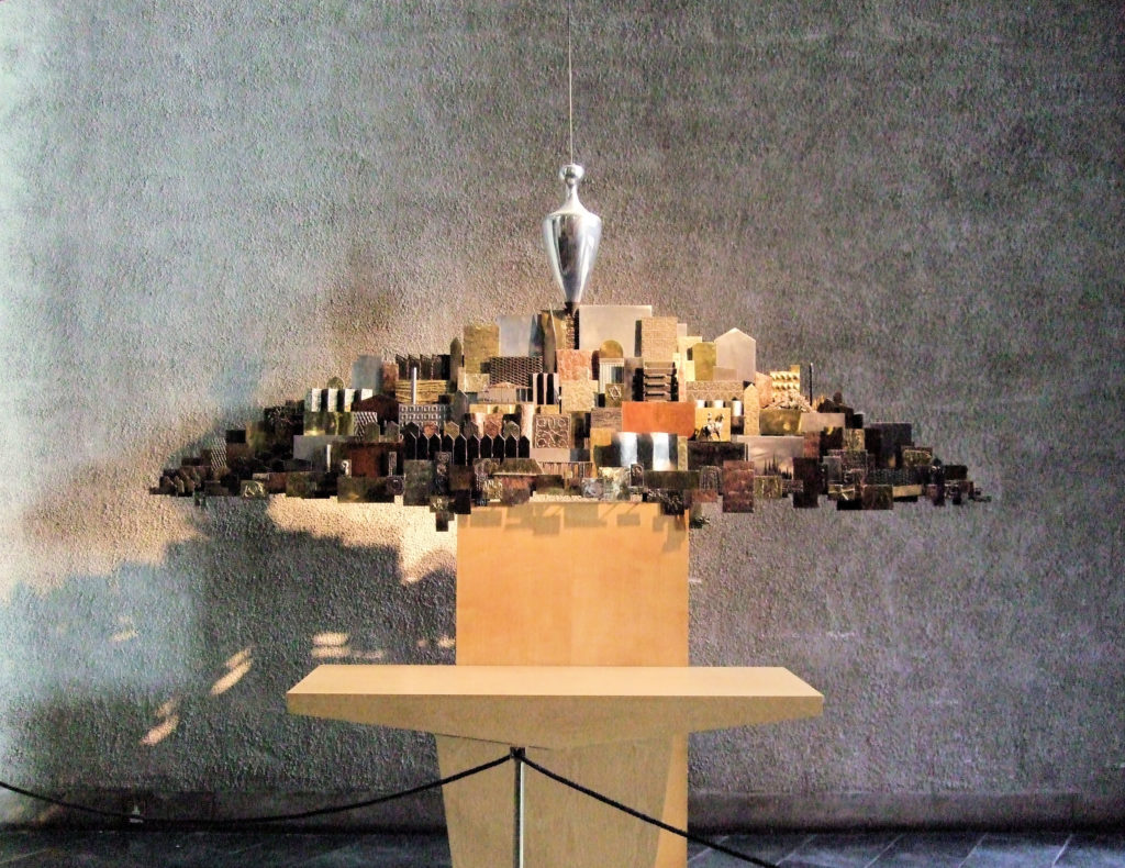 "The Plumb Line and the City" by Clark Fitzgerald, a sculpture in the new Coventry Cathedral depicting a city with the plumb line of judgement hanging above it.